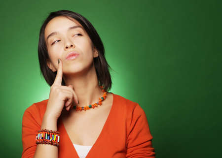 young expression woman over green background, happy timeの写真素材