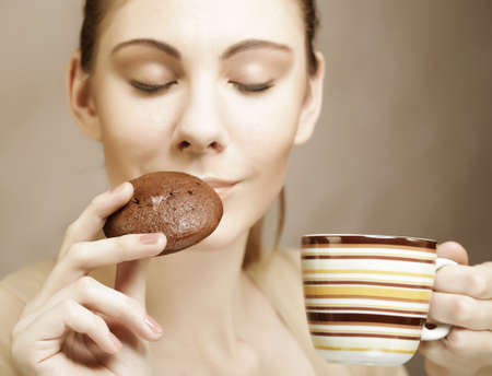 attractive woman with coffee and cookiesの写真素材