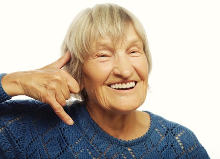 senior happy woman is making a call me gestureの写真素材