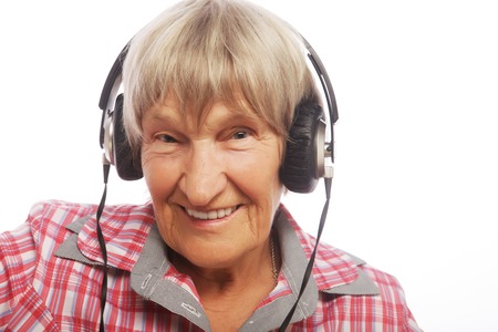 portrait of senior woman listening to music isolated on white