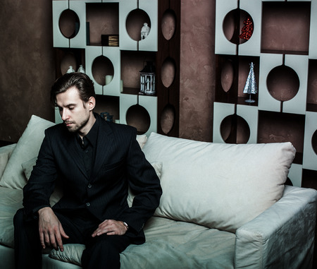 Businessman sitting on an armchair. Fahion man.の写真素材