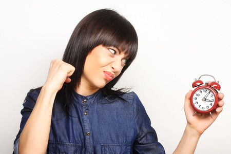 Young fun woman with alarmclock
