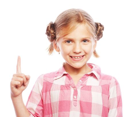Pretty school girl pointing her index finger upwards in excitement.の写真素材