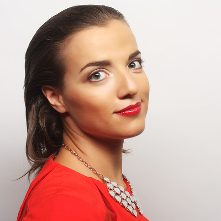 close up portrait young happy woman in red dressの写真素材