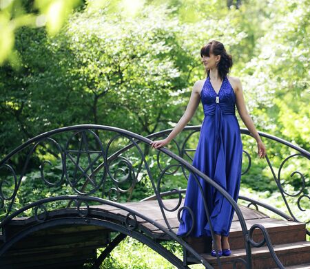 romantic woman with long dress in parkの写真素材