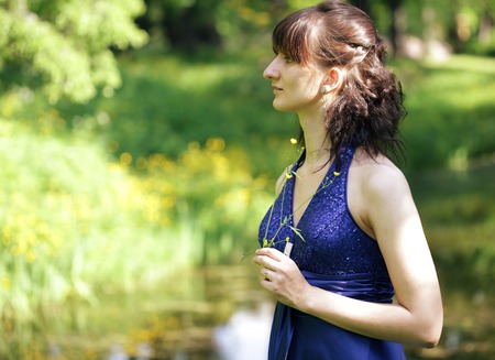 romantic woman with long dress in parkの写真素材
