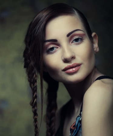 close up portrait of beautiful young blonde woman with creative braids hairdoの写真素材