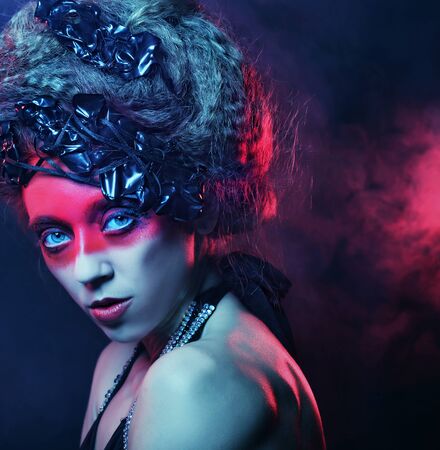 young woman with creative face-art, smoke backgroundの写真素材