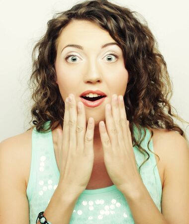 Beautiful young surprised woman. Studio shot.の写真素材