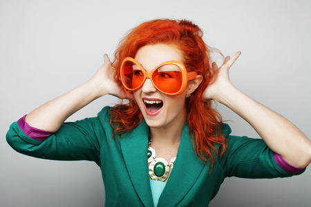 Party image. Playful young women holding a party glasses. Ready for good time.の写真素材