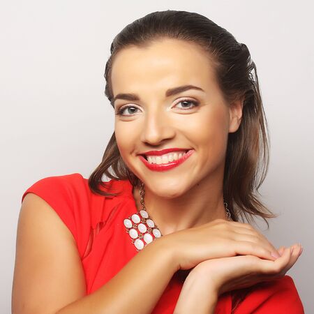 close up portrait young happy woman in red dressの写真素材