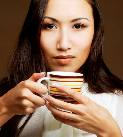 Beautiful asian woman drinking coffee or teaの写真素材