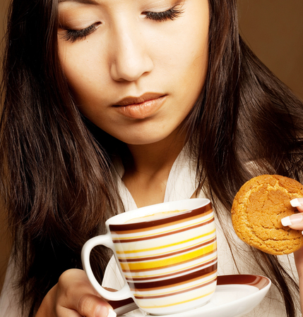 Beautiful asian woman drinking coffee or teaの写真素材