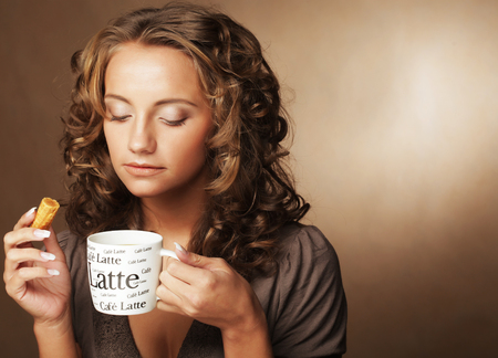 Young woman with an aromatic coffee in handsの写真素材