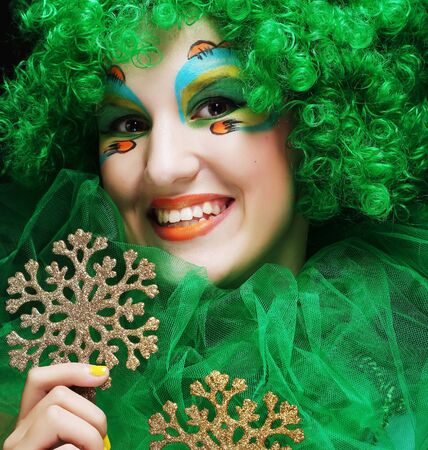 Beautiful lady with artistic make-up holding Christmas decorations.Doll style.の写真素材