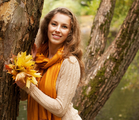 young smiling woman in  autumn parkの写真素材