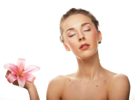 young woman with pink orchidの写真素材