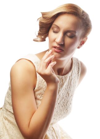 young blonde in white dress posingの写真素材