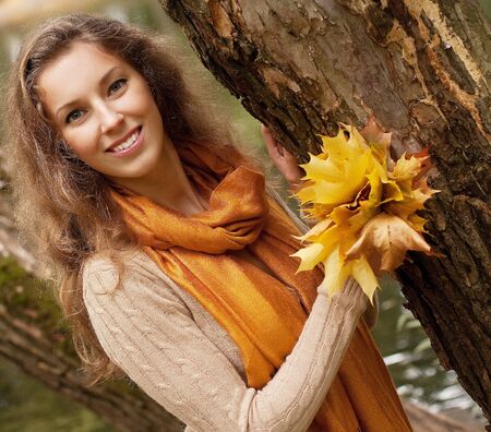 young smiling woman  in autumn parkの写真素材