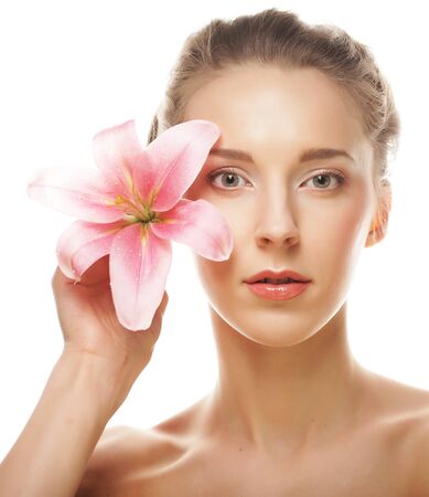 Beauty face of the young woman with pink lilyの写真素材