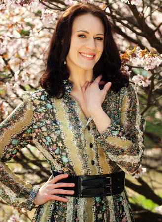 woman in spring flowers gardenの写真素材