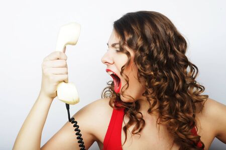 young curly woman with vintage phone.の写真素材