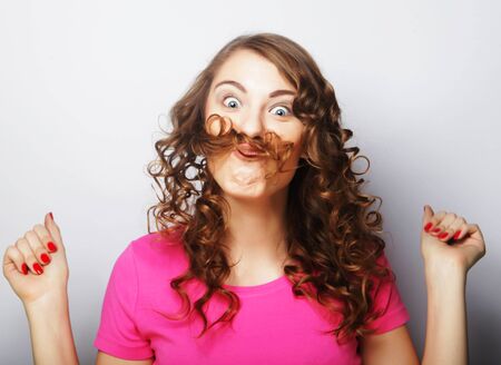 Beautiful young surprised woman. Studio shot.の写真素材