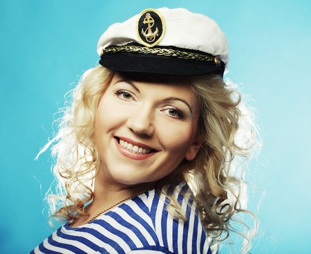 Happy blond woman on blue backgroundの写真素材