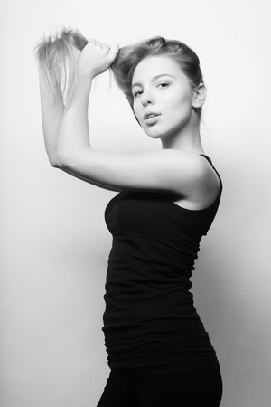 Beautiful woman with long blond hair. Fashion model posing at studio.の写真素材