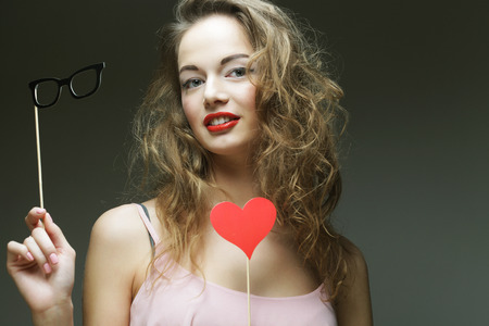 Party image. Playful young women holding a party glasses. Ready for good time.の写真素材
