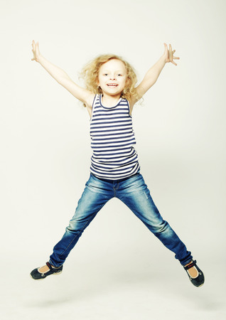 happy curly girl jumps on a white backgroundの写真素材