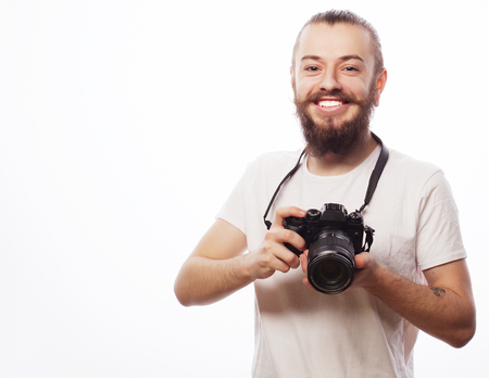 life style, tehnology and travel concept: bearded man wearing white t-shirt with a digital camera...