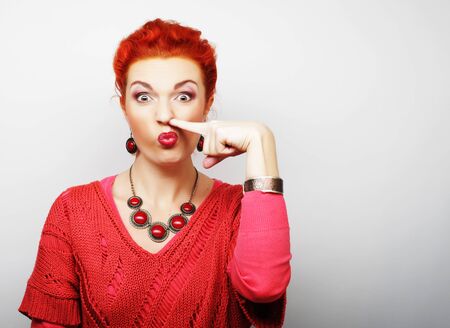Beautiful young surprised woman. Studio shot.の写真素材