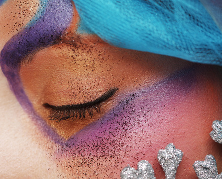 Macro close-up of beautiful female eye with bright creative make-upの写真素材