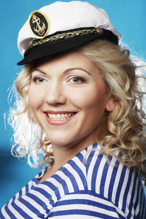Happy blond woman on blue backgroundの写真素材