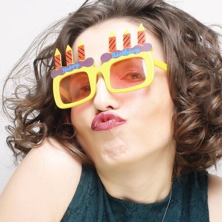 young happy woman with big orange sunglassesの写真素材