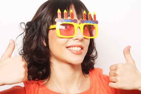 young happy woman with big orange sunglassesの写真素材
