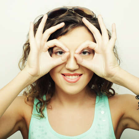 Beautiful young surprised curly woman. Studio shot.