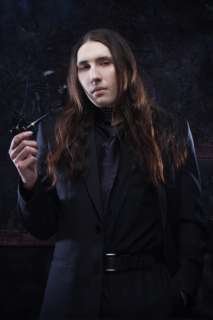 Handsome young man with long hairの写真素材