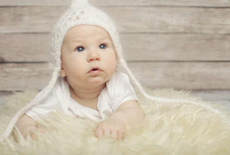 Adorable  baby boy in white hatの写真素材