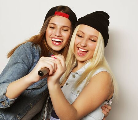 two young hipster girls singingの写真素材