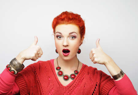 Successful happy girl gives thumb up with two hands