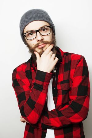 Young bearded hipster man wearing eyeglasses. Over white background.の写真素材