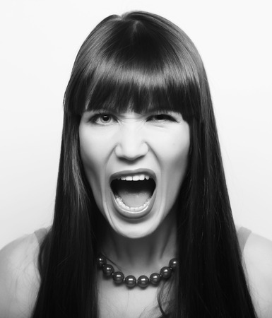 Beautiful young surprised woman. Studio shot.の写真素材