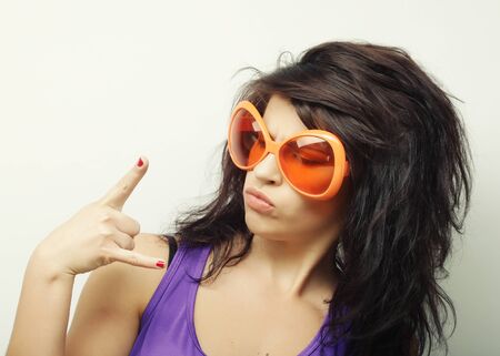 young funny woman with big orange sunglasses
