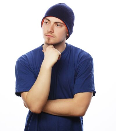 Life style, sport and people concept - young handsome man in blue t-shirt and blue hat.の写真素材