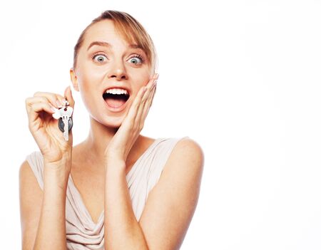 Business, real estate and office concept: young businesswoman with key. Positive emotion. Isolated...