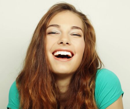 Beautiful young surprised woman. Studio shot.