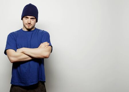 Life style, sport and people concept - young handsome man in blue t-shirt and blue hat.の写真素材