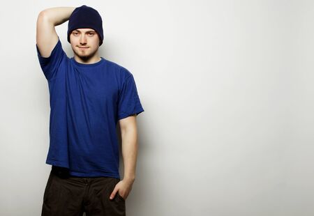 Life style, sport and people concept - young handsome man in blue t-shirt and blue hat.の写真素材